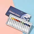 A 12-piece ceramic paint tube set displayed in an open tray next to its dark blue box. The tubes are arranged in a row showing various paint colors including yellow, orange, red, brown, green, blue, and black.