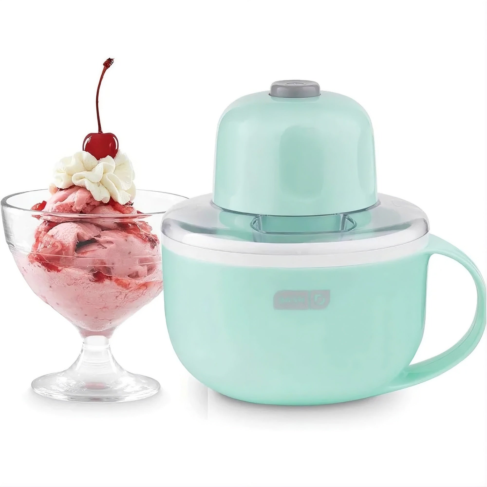 A mint green countertop ice cream maker shown next to a glass bowl of pink strawberry ice cream topped with whipped cream and a cherry, on a white background.