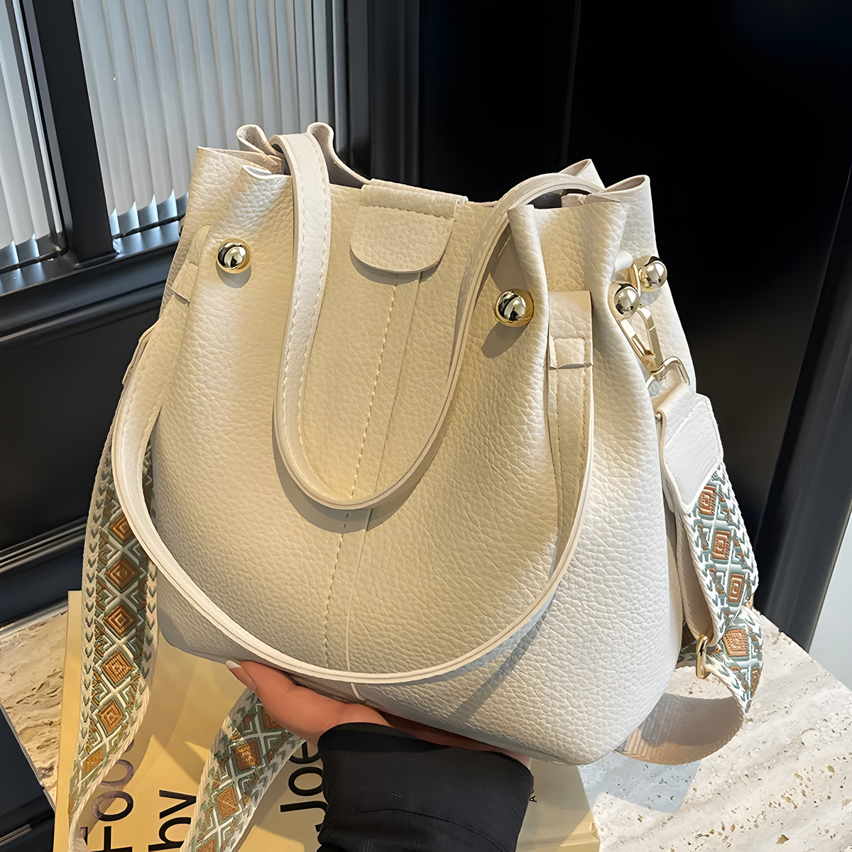 Compact Bucket Handbag with Wide Patterned Shoulder Strap