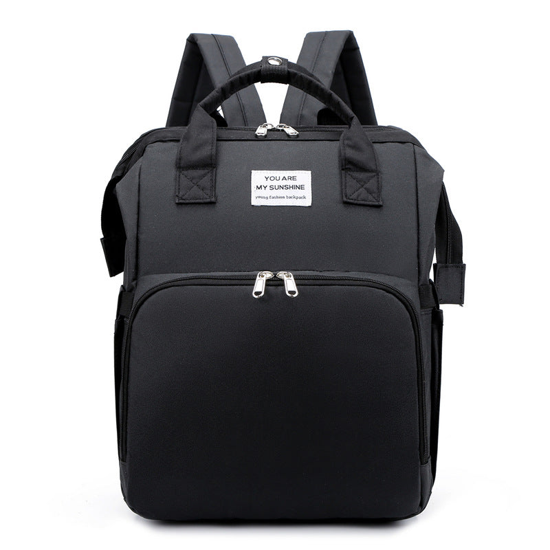 Black backpack with a visible label on a white background