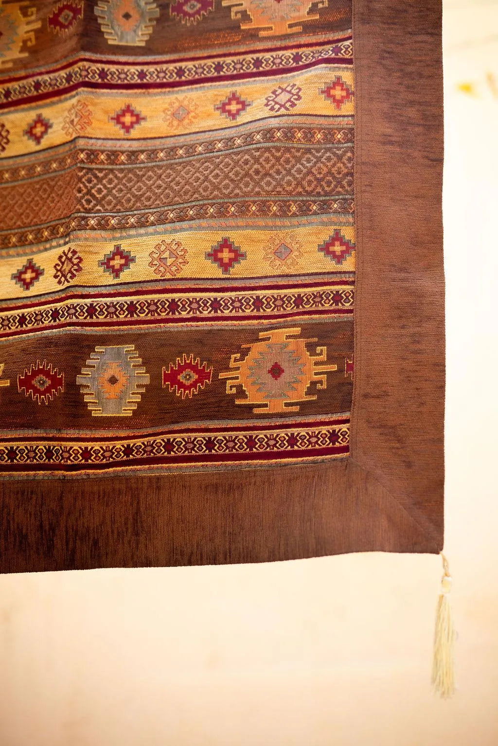 Brown and yellow rug bands with stepped medallions and red geometric accents