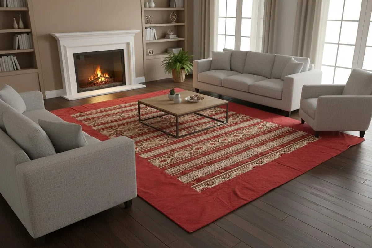 Staged living room featuring a red Turkish rug with cream geometric stripes and wide red border