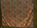 Square olive Turkish rug with red floral motifs, cream-outlined leaves and a wide green border