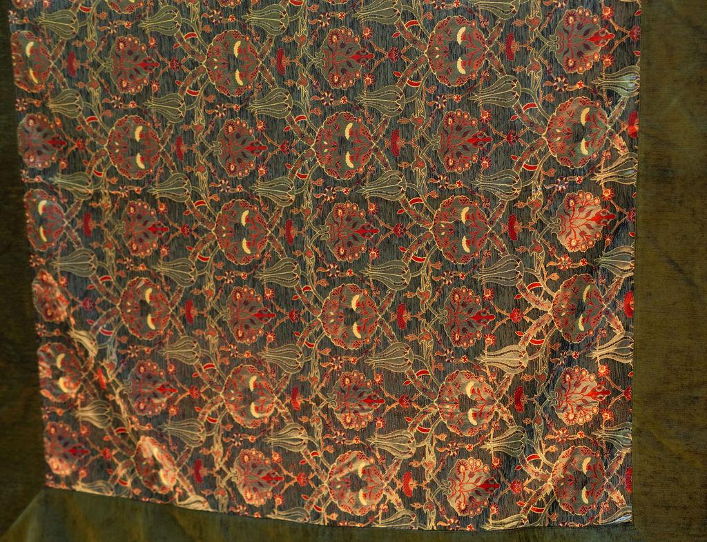 Square olive Turkish rug with red floral motifs, cream-outlined leaves and a wide green border
