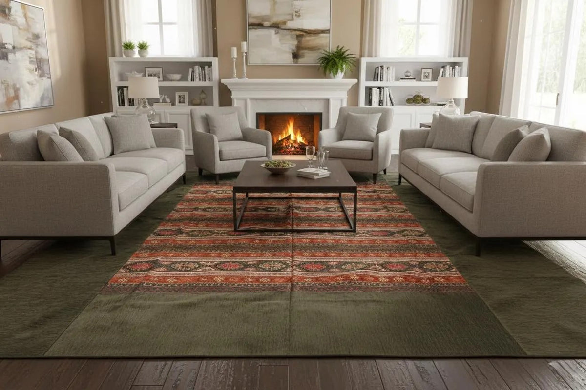 Olive-bordered Turkish rug spread on sand showing its patterned central panel