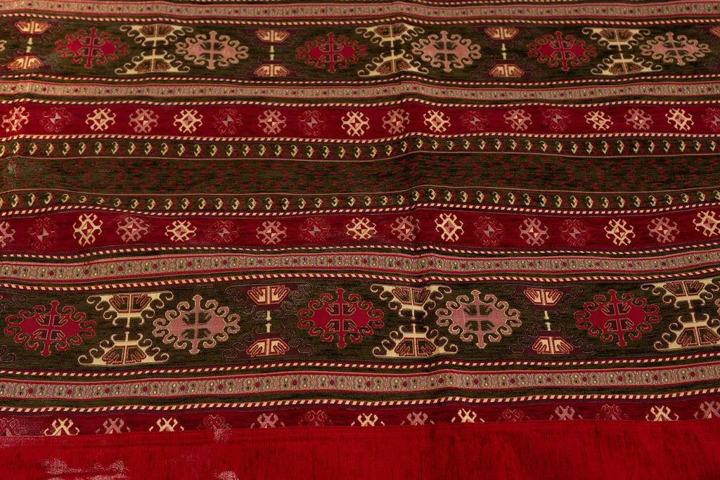 Close-up of repeating geometric motifs in burgundy, beige and olive bands