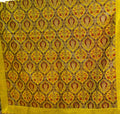 Yellow Turkish rug with repeating floral medallions and a wide plain yellow border